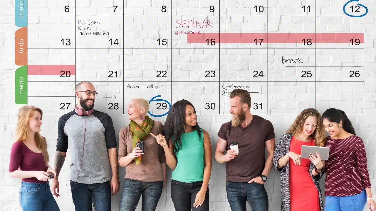 workers in front of wall calendar
