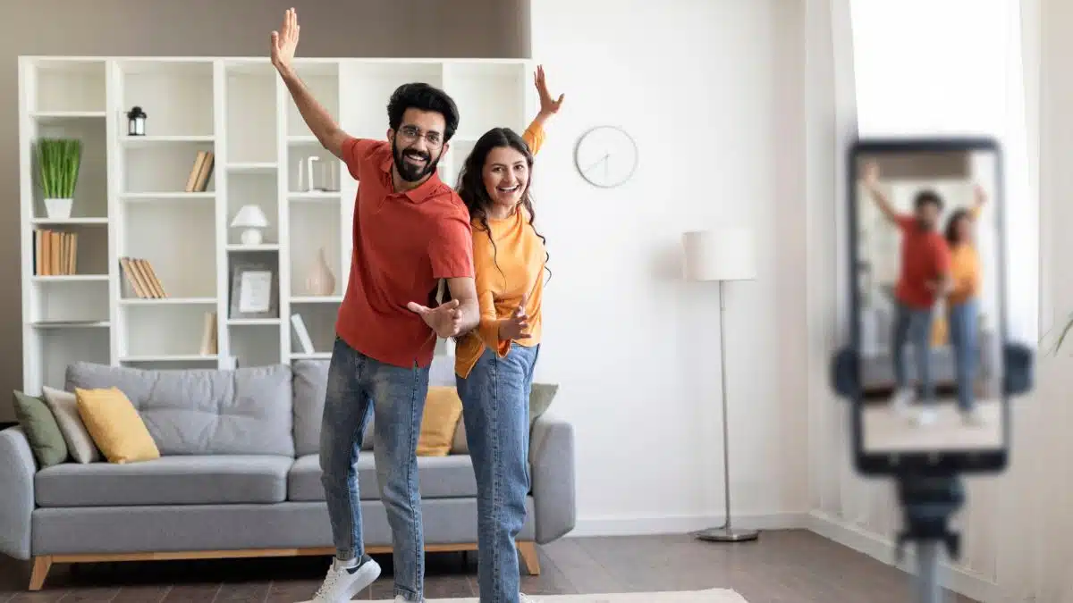 couple making dancing video in the living room
