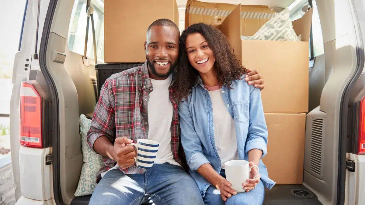 couple with a moving truck with coffee