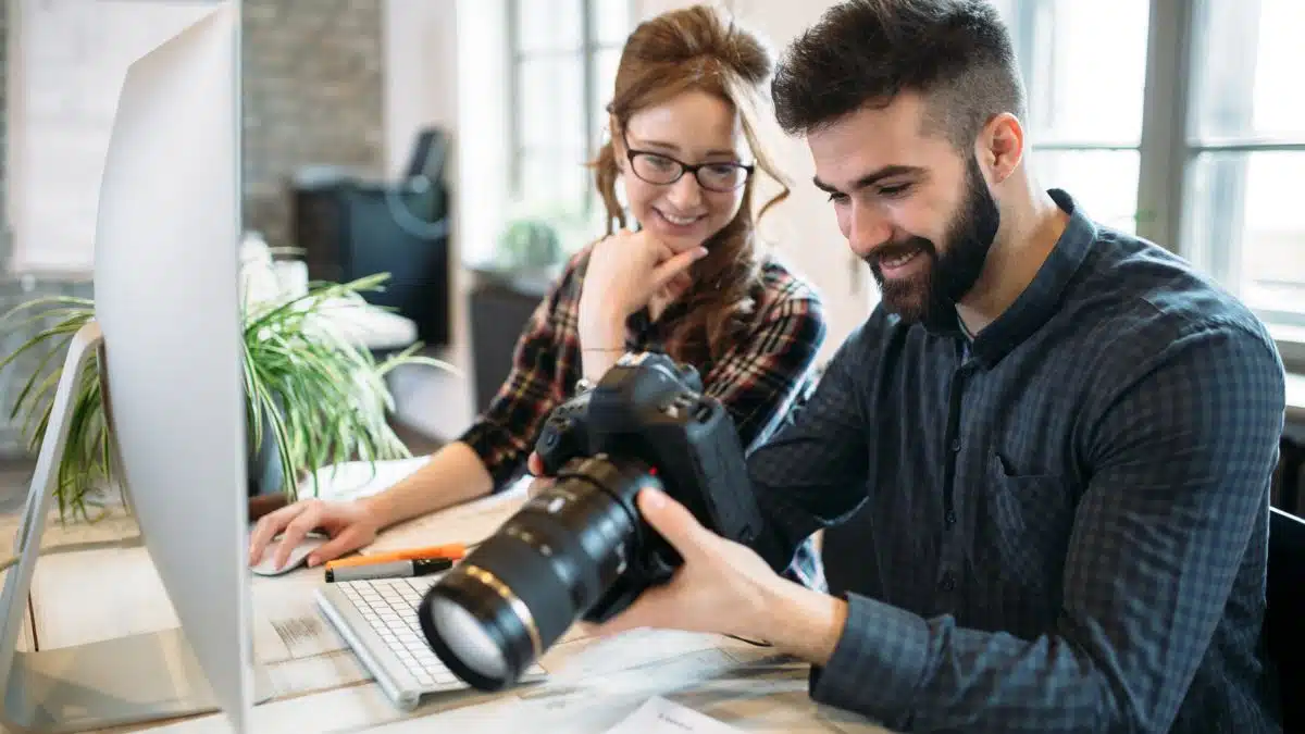 couple photographers looking at their camera