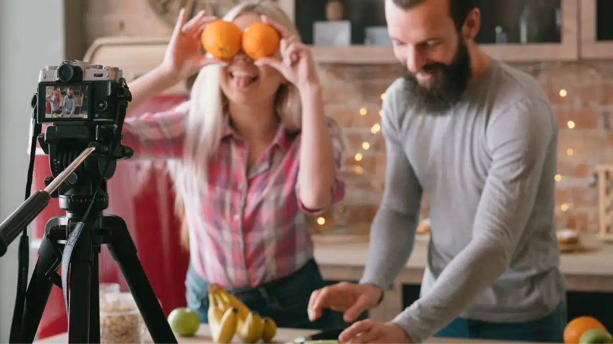 couple recording cooking video in their kitchen