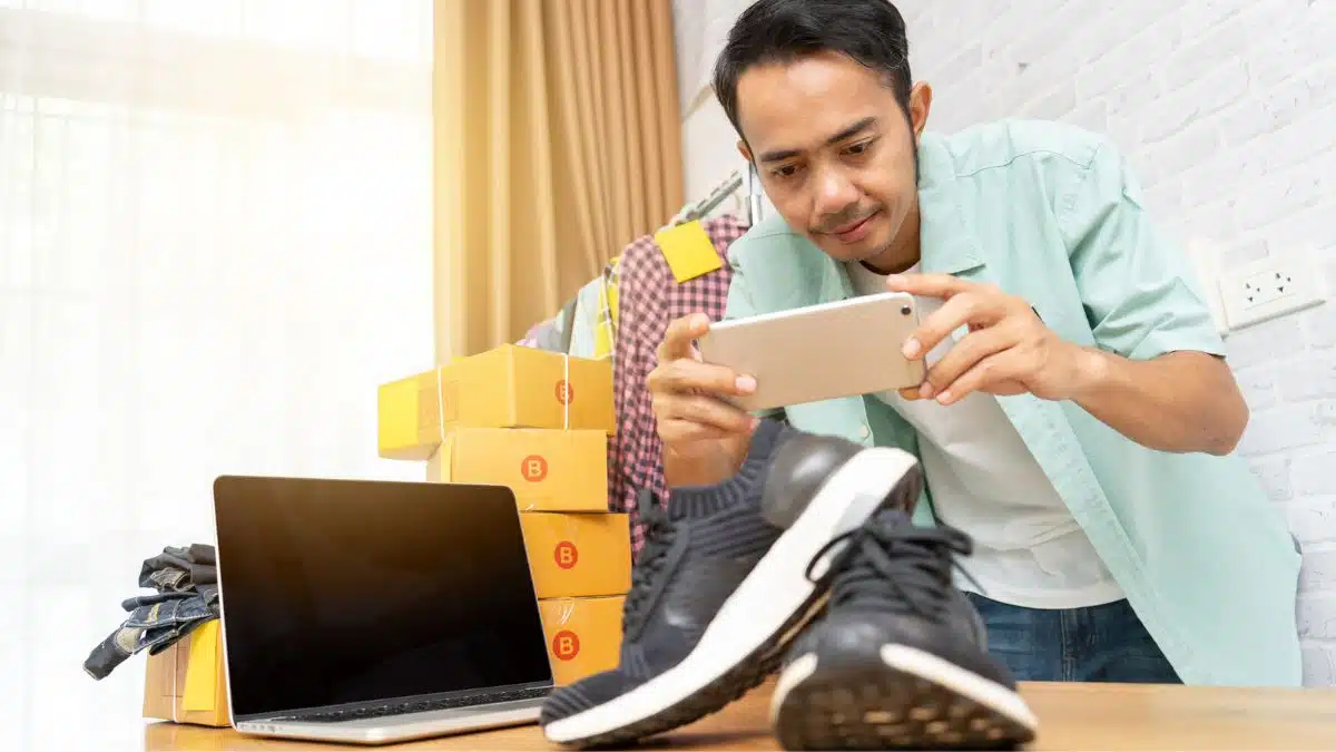 man taking photos of shoes to sell