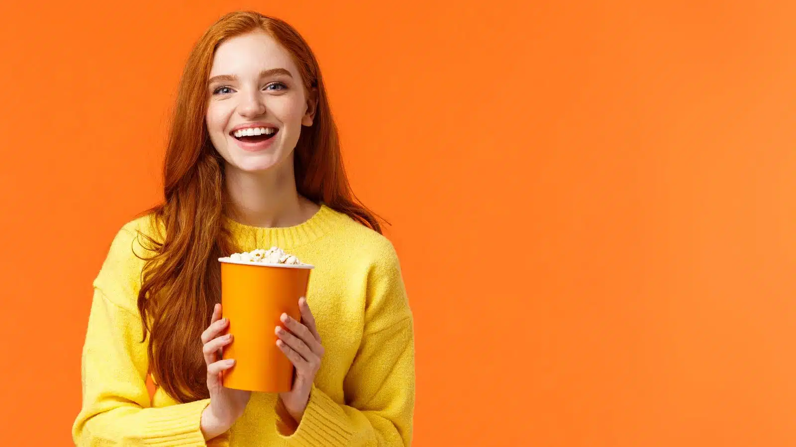Redhead girl holding popcorn