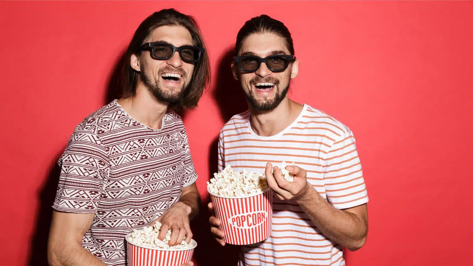 twins watching a 3d movie with popcorn