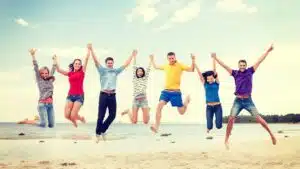 happy friends jumping on the beach