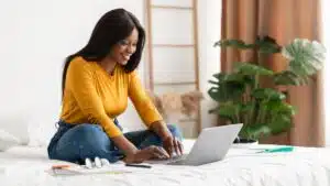 happy woman working on a laptop at home