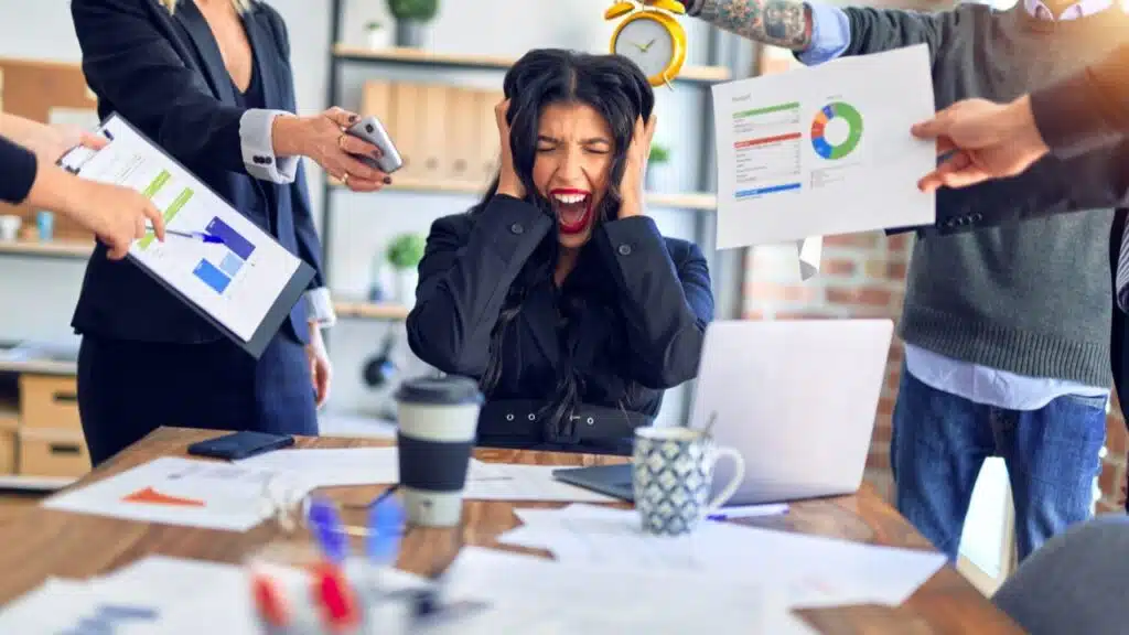 businesswoman being overwhelmed by work stress