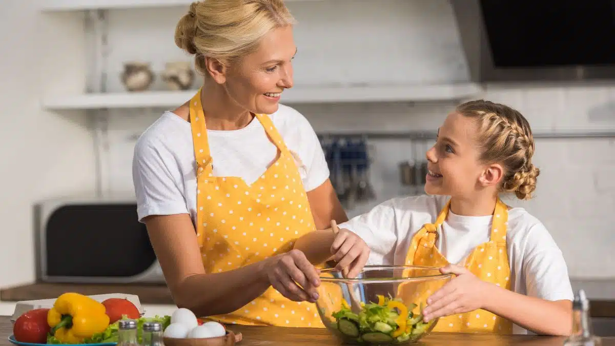 grandma and granddaughter making salad