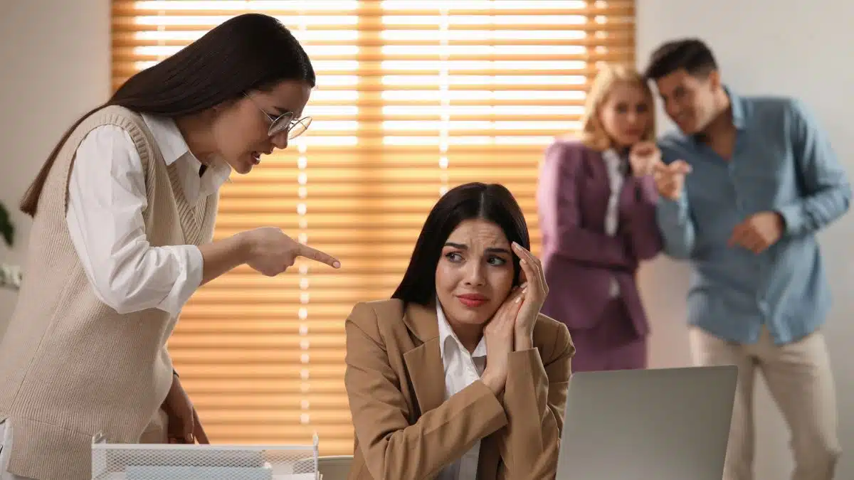 toxic coworkers bullying woman at her desk