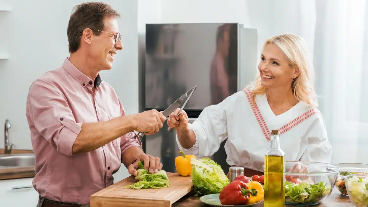 couple cooking healthy meal in the kitchen