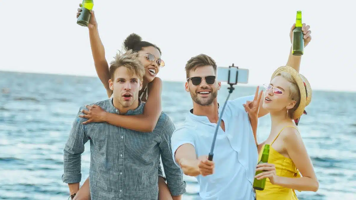 friends drinking on the beach taking a selfie
