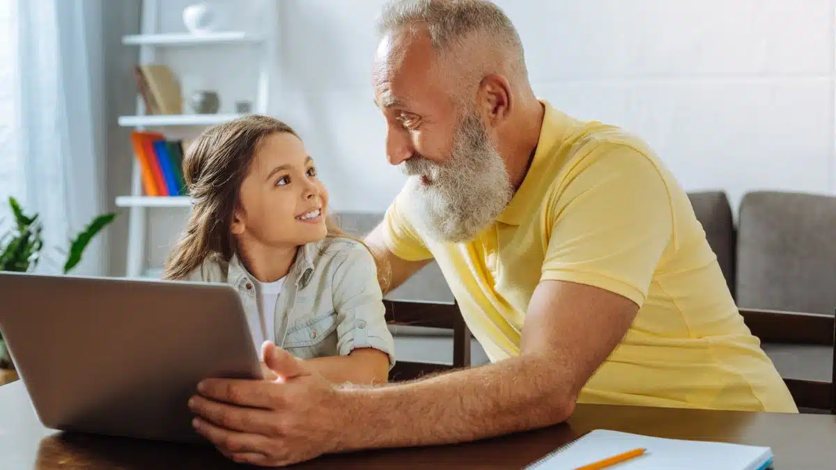 grandpa and grandchild with laptop