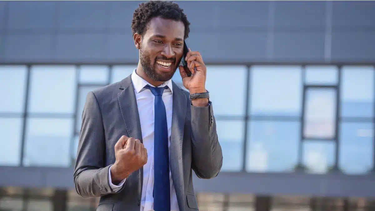 happy businessman on the phone celebrating