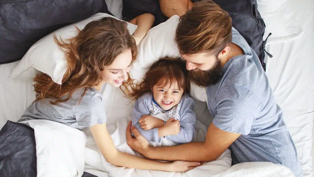 happy family laying in bed