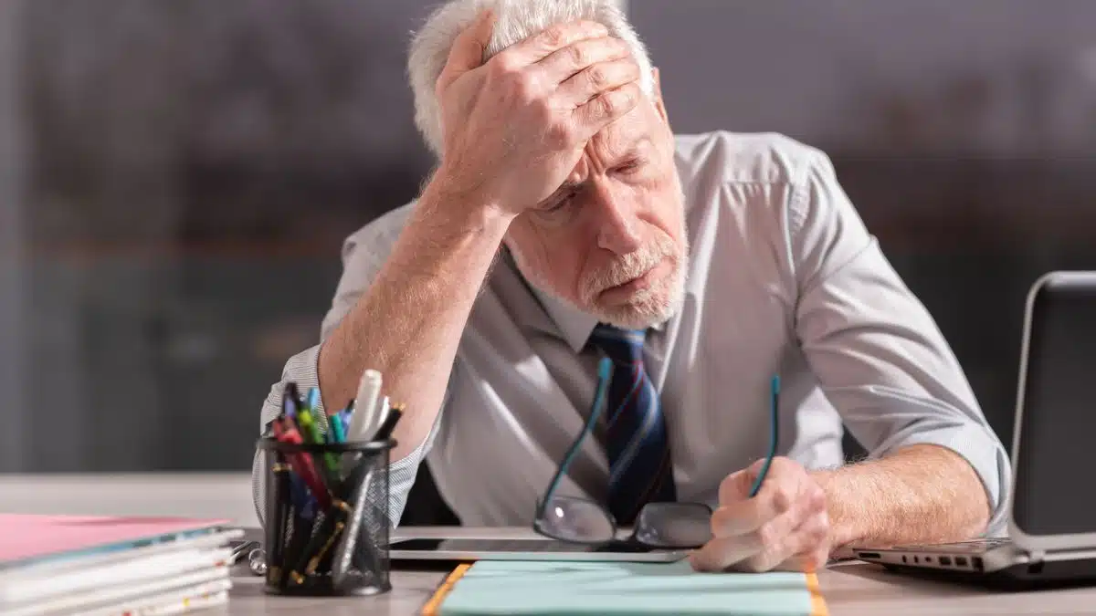 tired mature employee at his desk