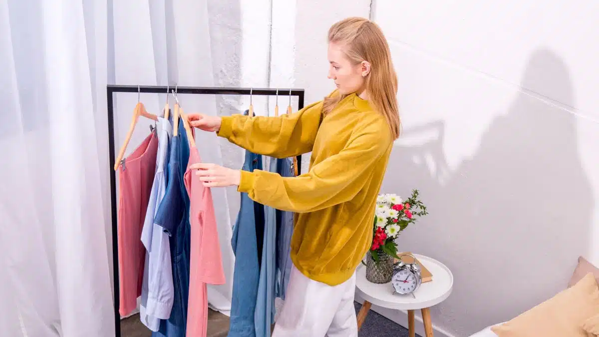 woman choosing clothes from her closet
