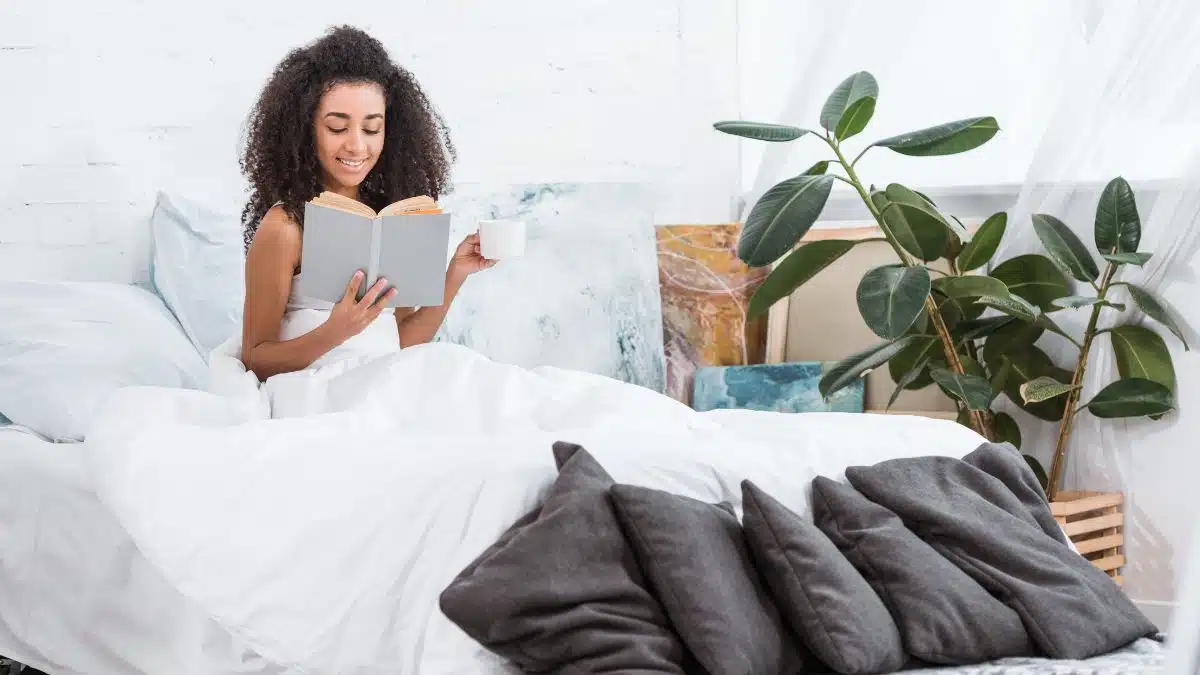 woman reading in bed with coffee