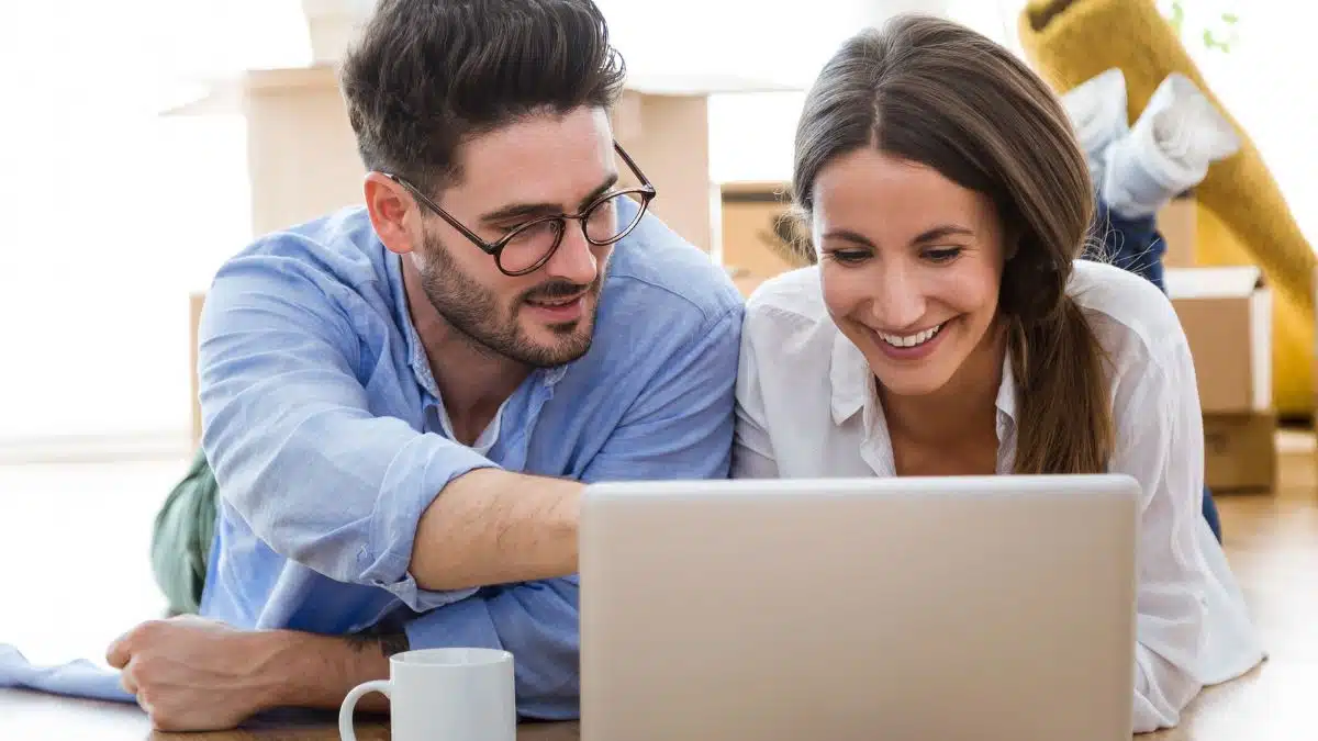 happy blogging couple in their home