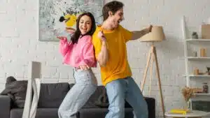 couple dancing at home in the living room