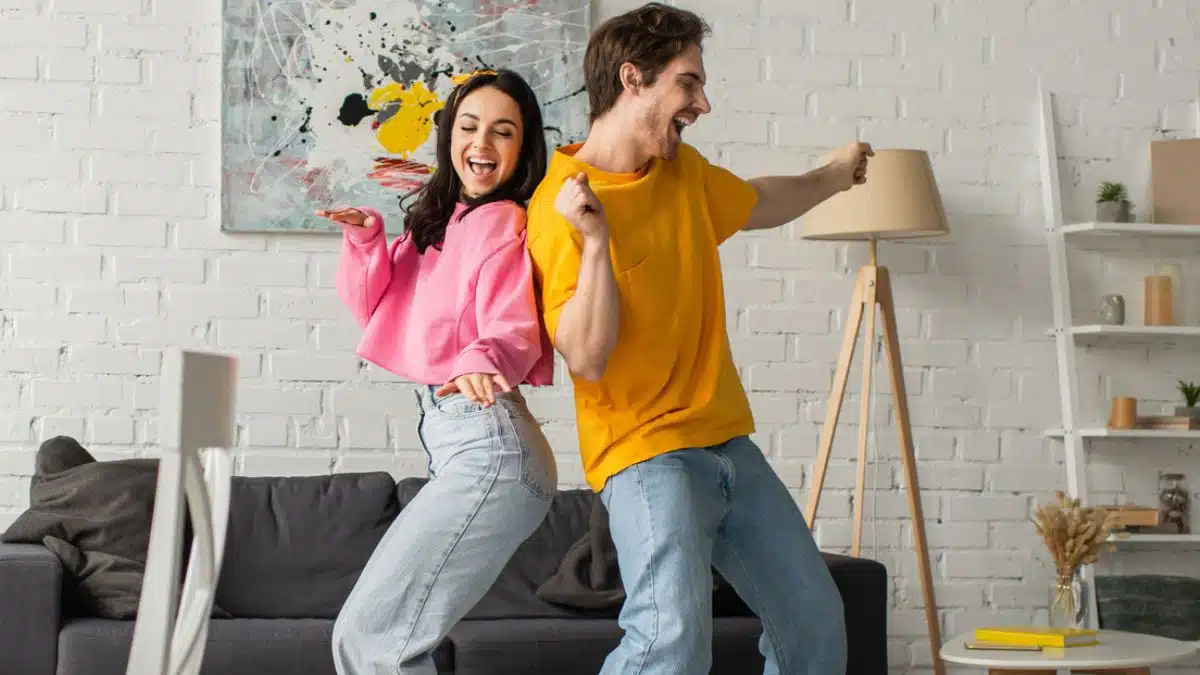 couple dancing at home in the living room