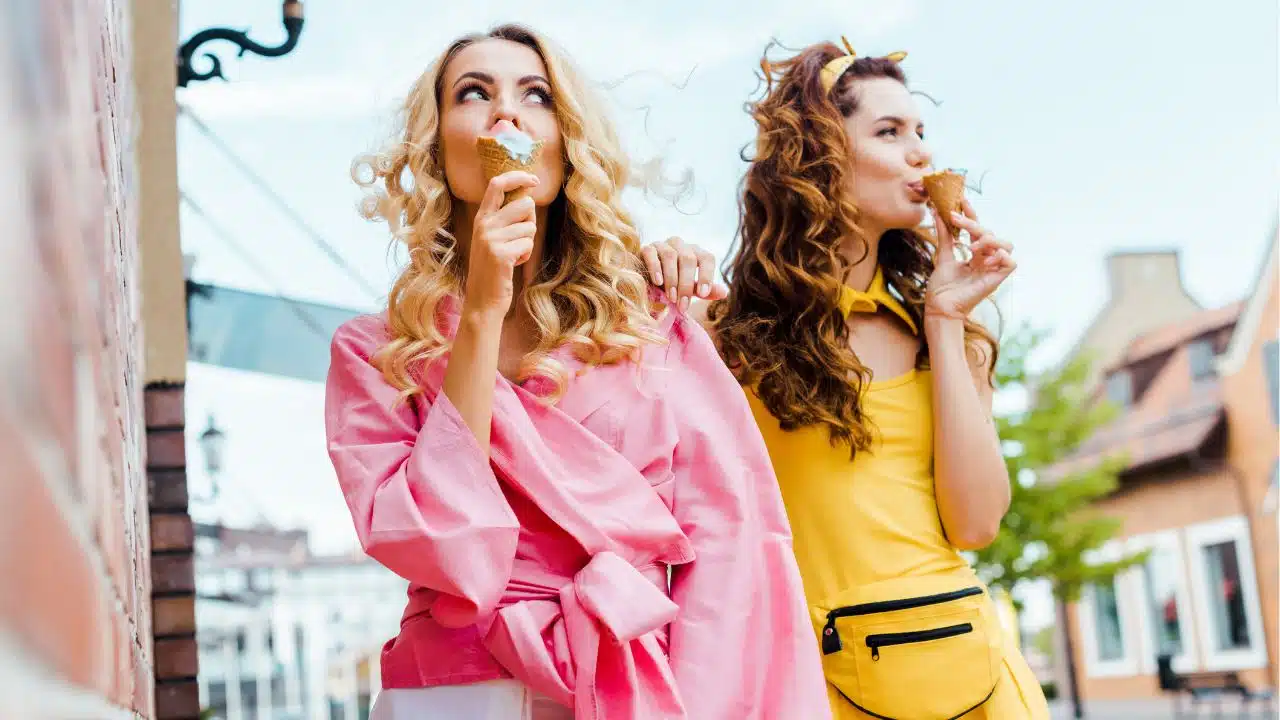 fashionable women with ice cream cones outside