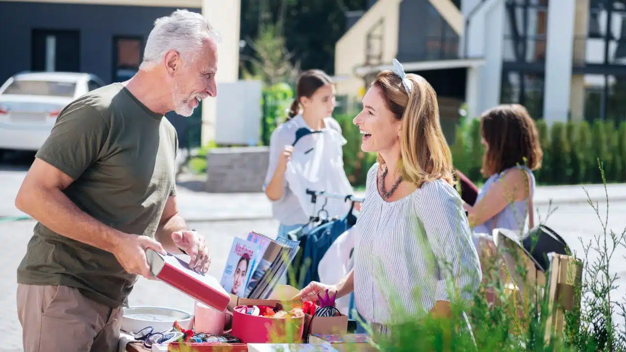 two people laughing at yard sale