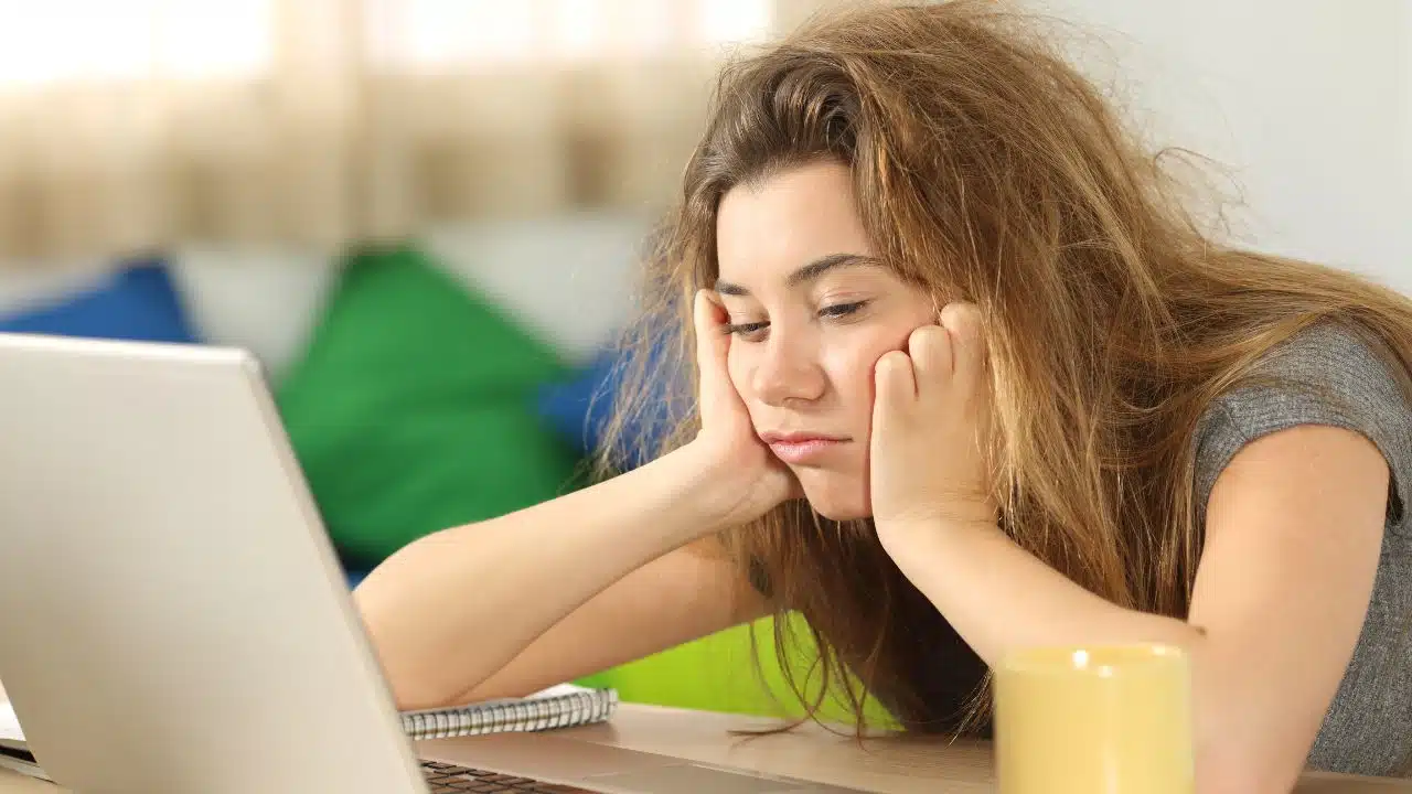 young woman tired of waiting at her laptop