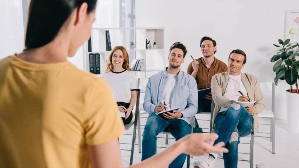 coworkers listening to a presentation at work