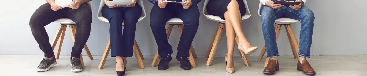 background image of people sitting, waiting for a job interview