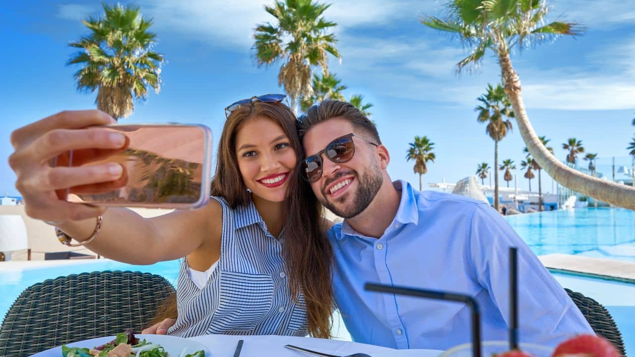 rich couple on vacation taking a selfie
