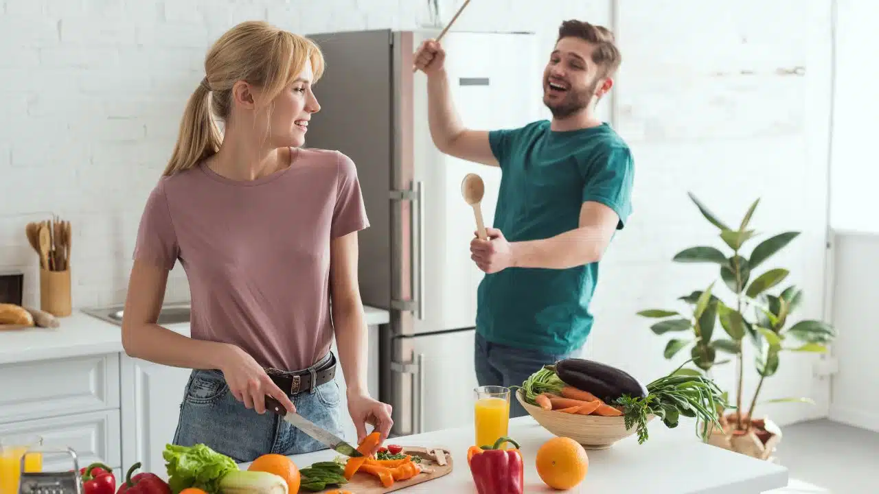 couple cooking healthy foods together, having fun in the kitchen