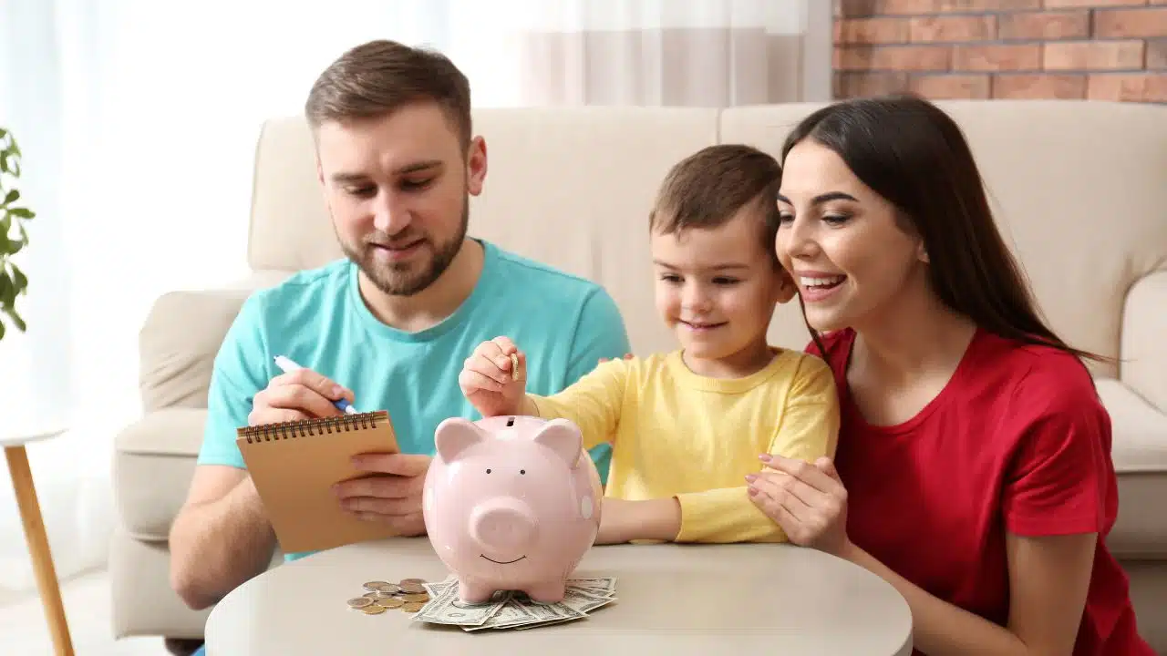 parents and son saving money in a piggy bank