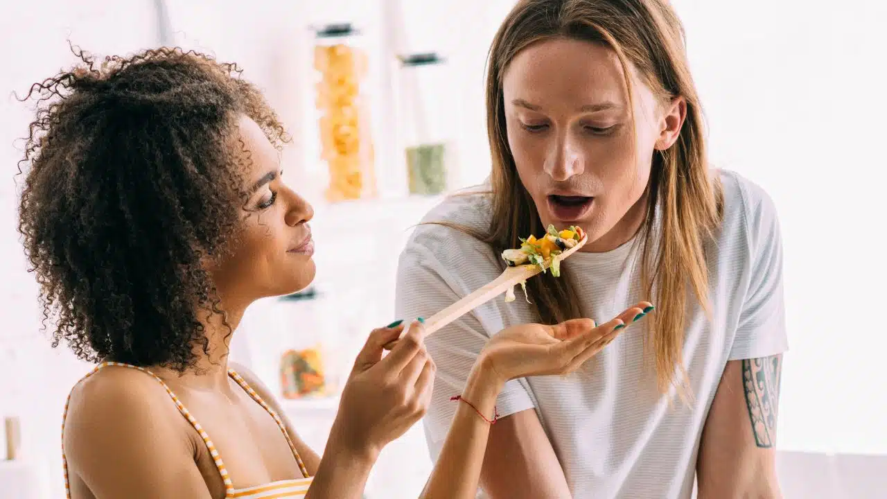 couple cooking tasting food