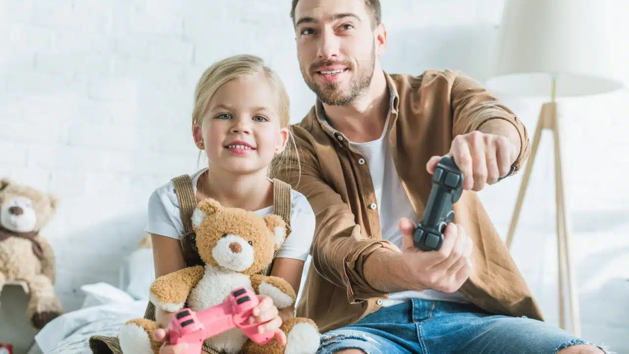 father and daughter playing video game