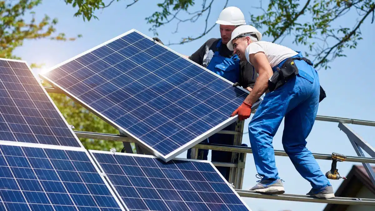 Two technicians installing solar panels MSN