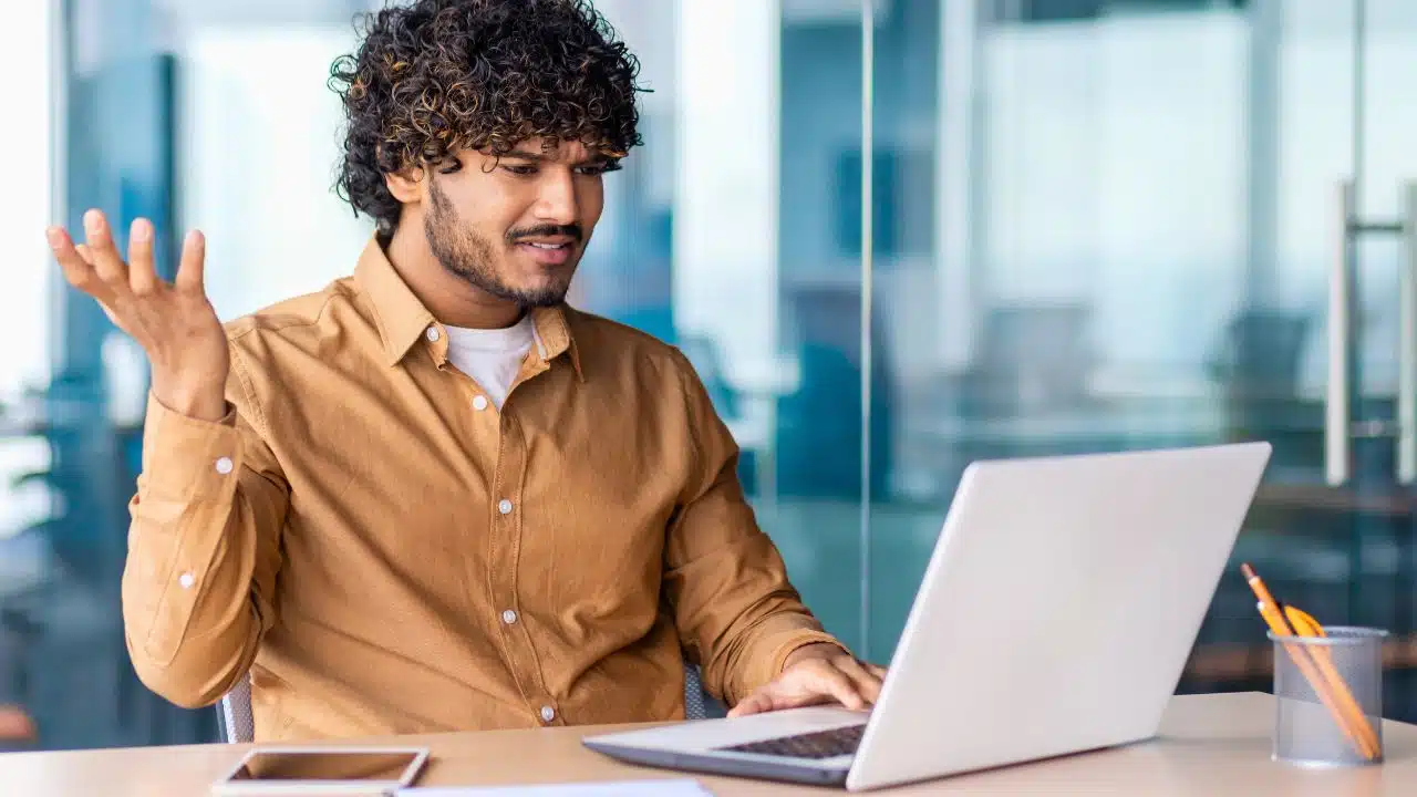 angry worker shrugging at laptop confused