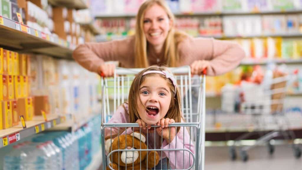 cute girl sitting in a shopping cart