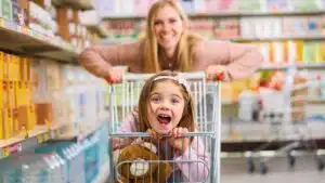 cute girl sitting in a shopping cart
