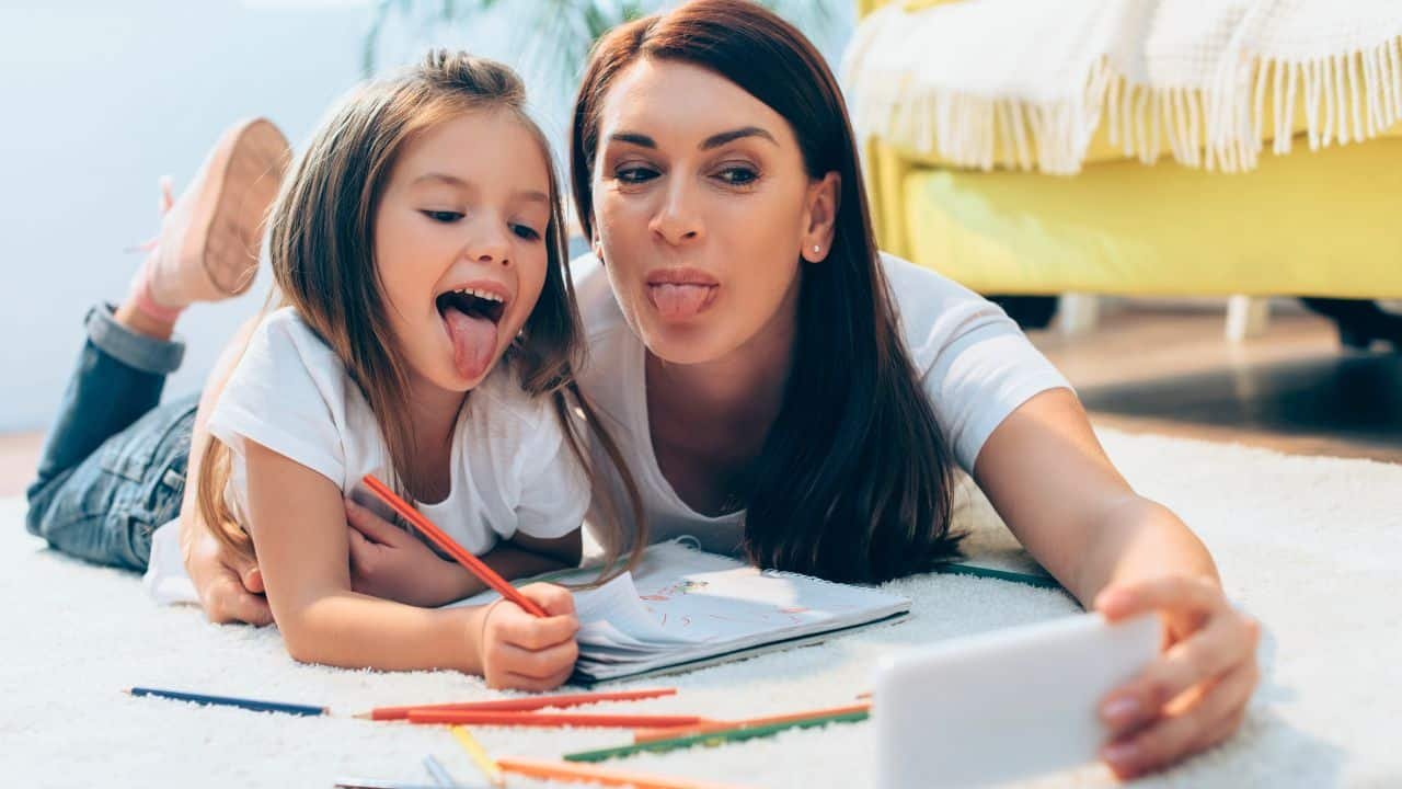 funny mom and daughter coloring and taking a selfie
