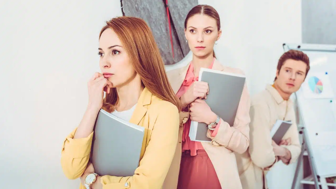 line of candidates with portfolios waiting for interview