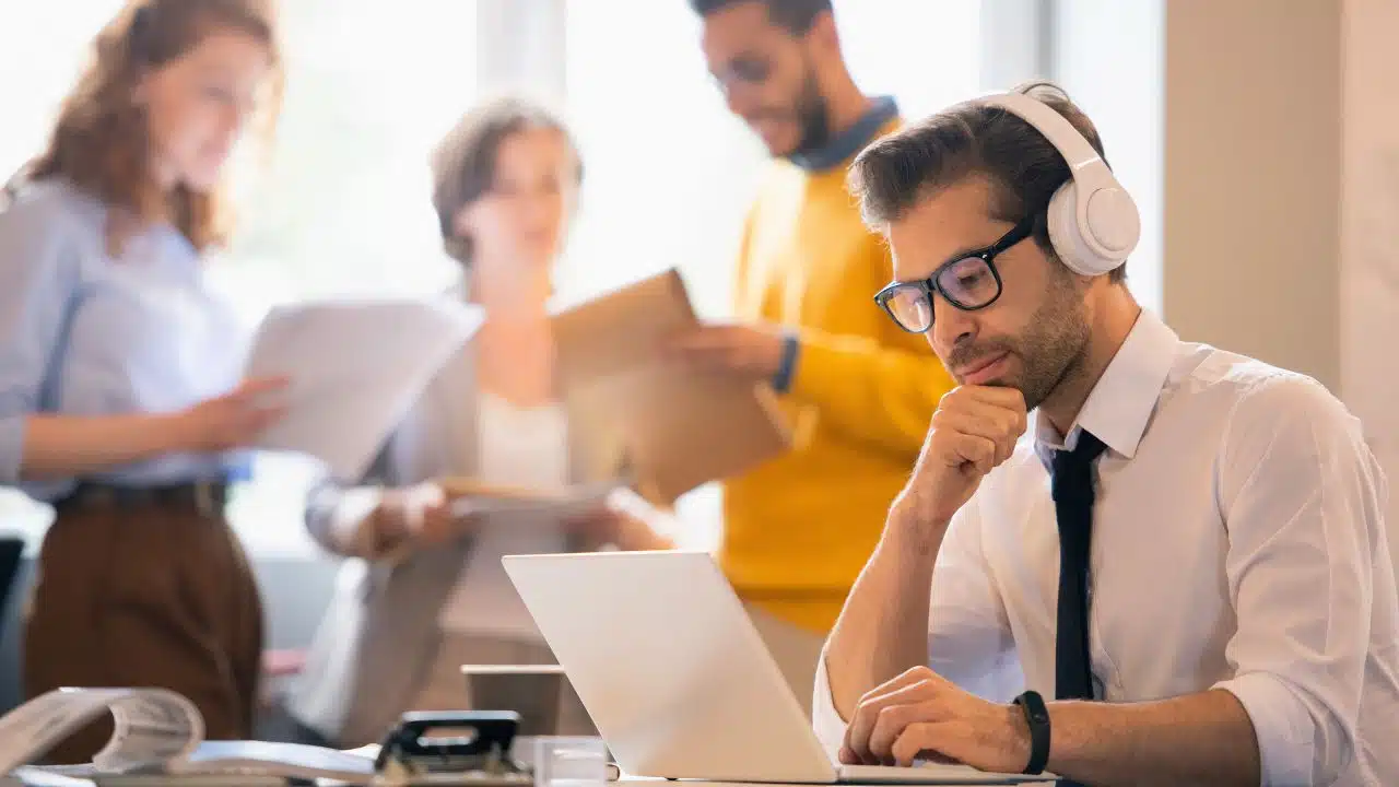 man with headphones working in office