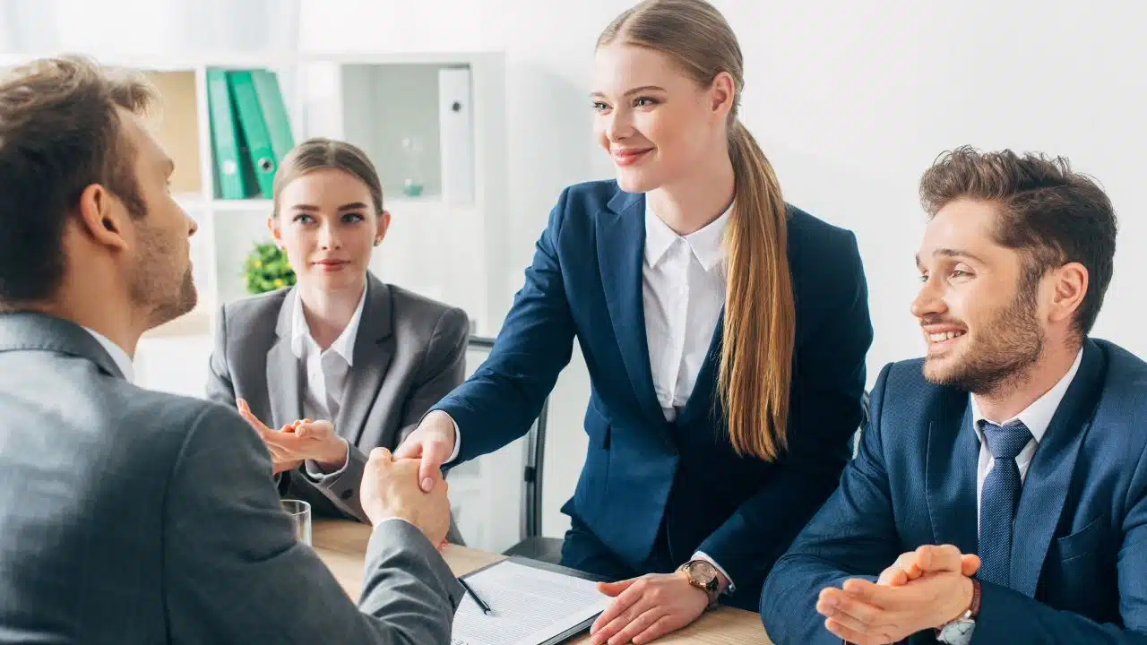 shaking hands at panel job interview