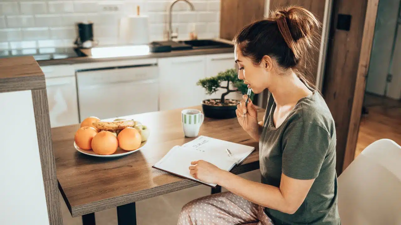 woman in pajamas planning her schedule