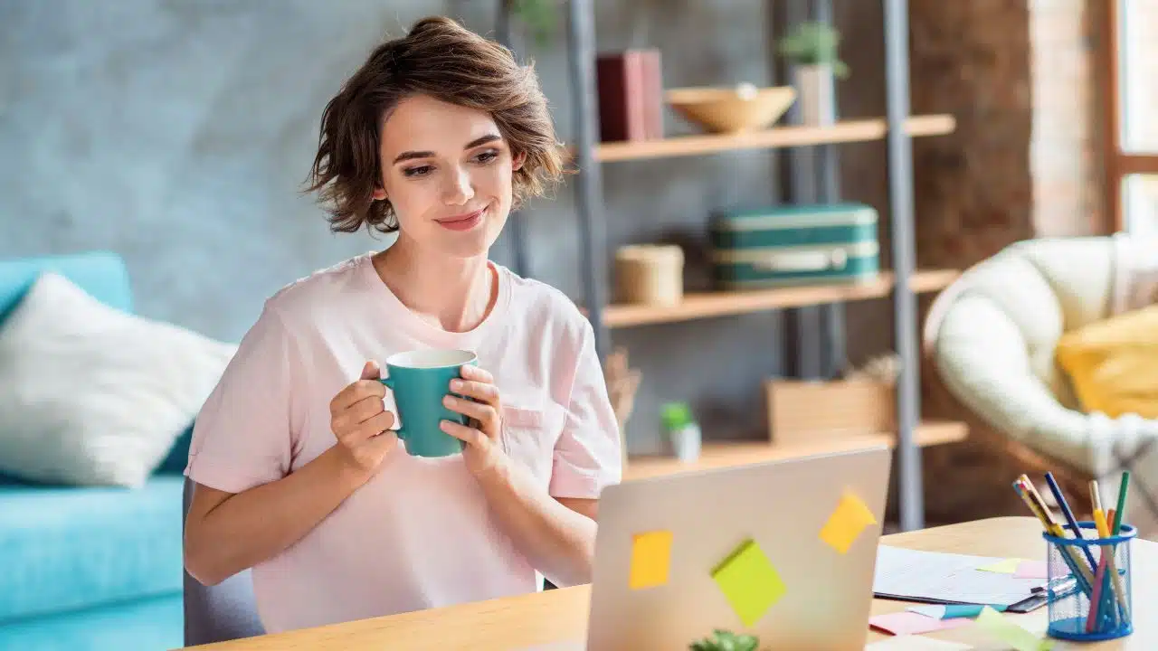 young woman working on laptop at home