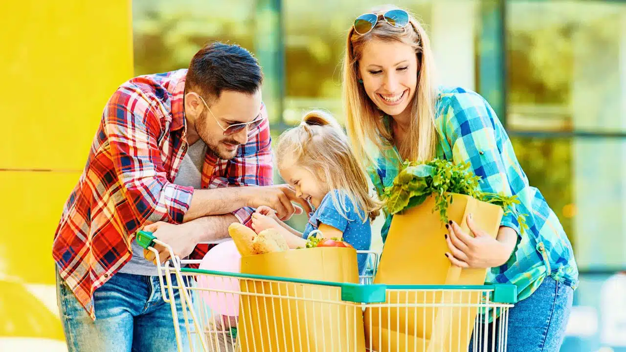 happy young family outside grocery store