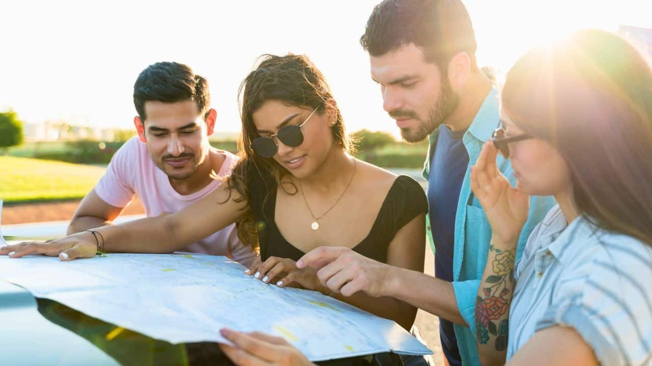 lost friends looking at map on roadtrip