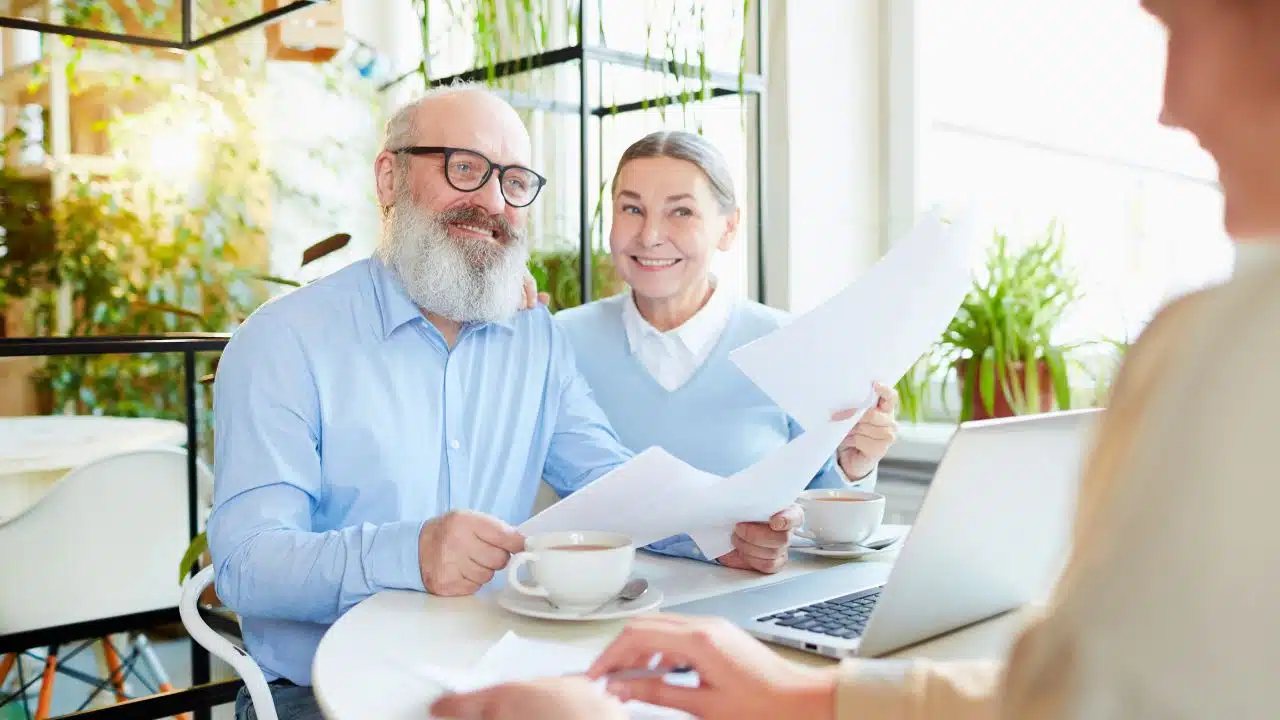 mature couple at meeting in cafe with paperwork