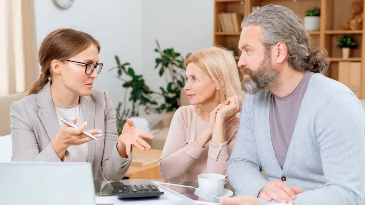 mature couple meeting with advisor at home