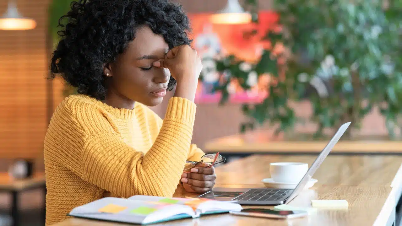 stressed young woman with planner and laptop