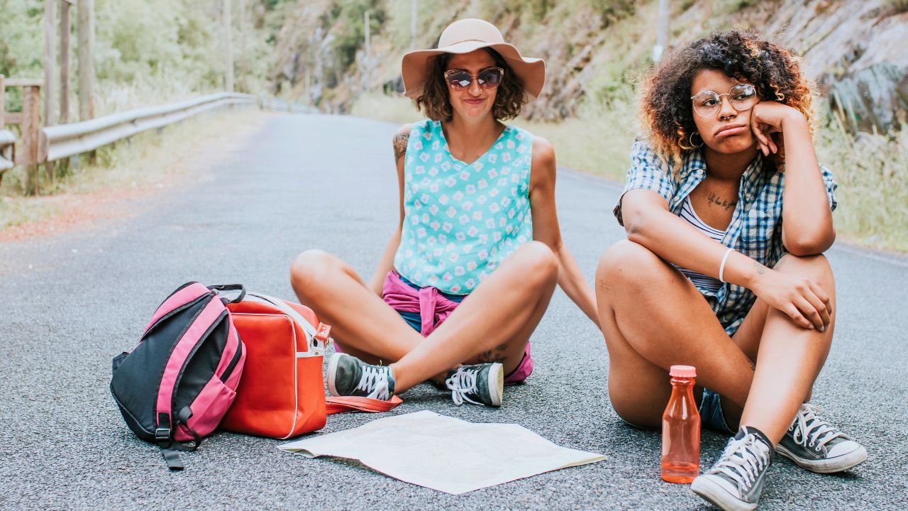 tired girls taking a break from hiking
